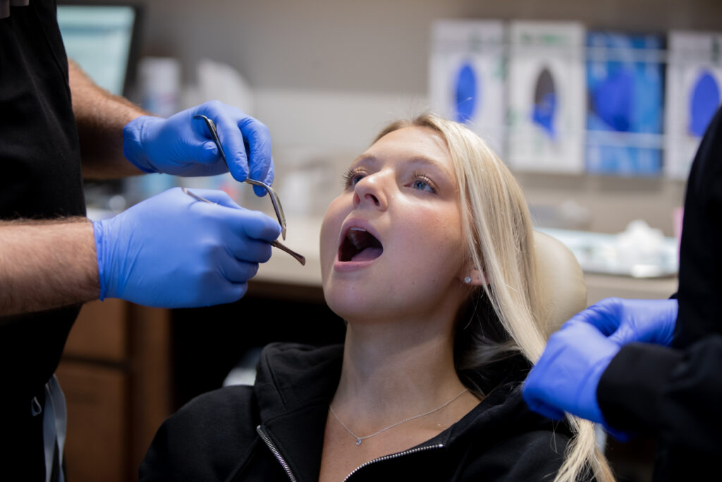 patient with mouth open receiving a consultation