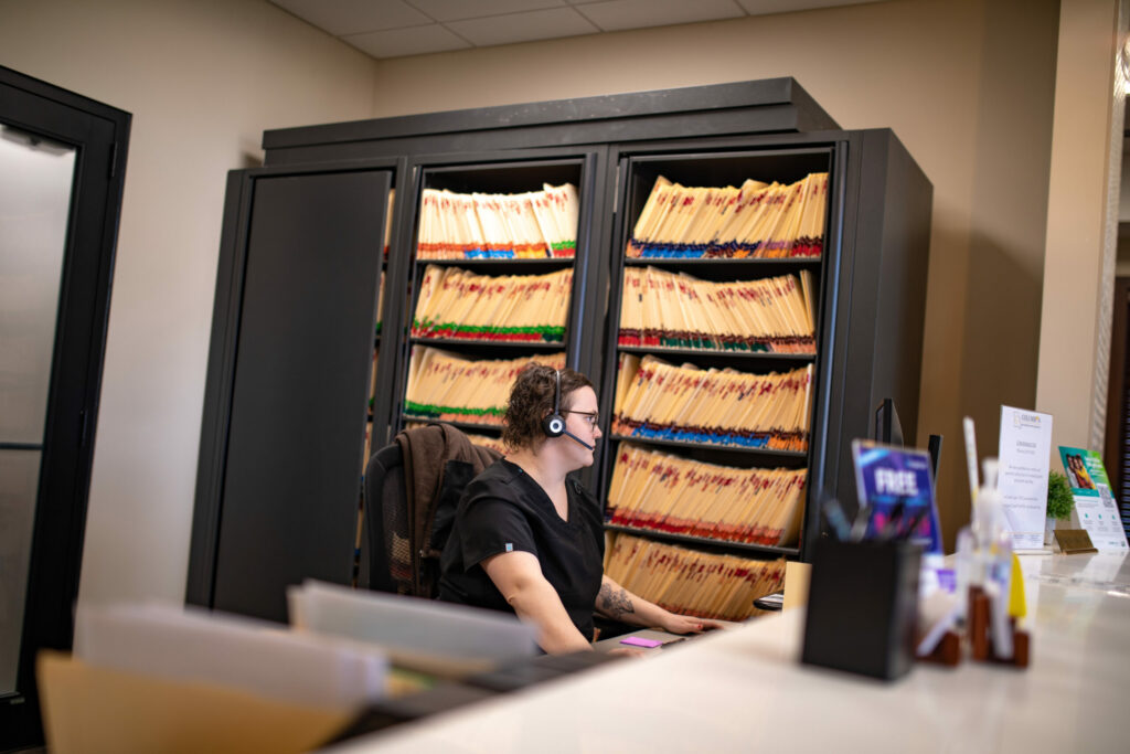 Desert Valley Oral Surgery employee on the phone helping with insurance information