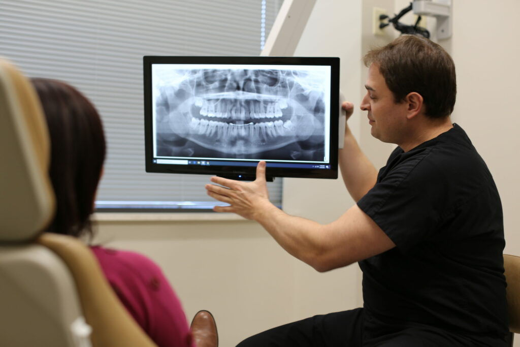 surgeon showing a patient her dental x-rays